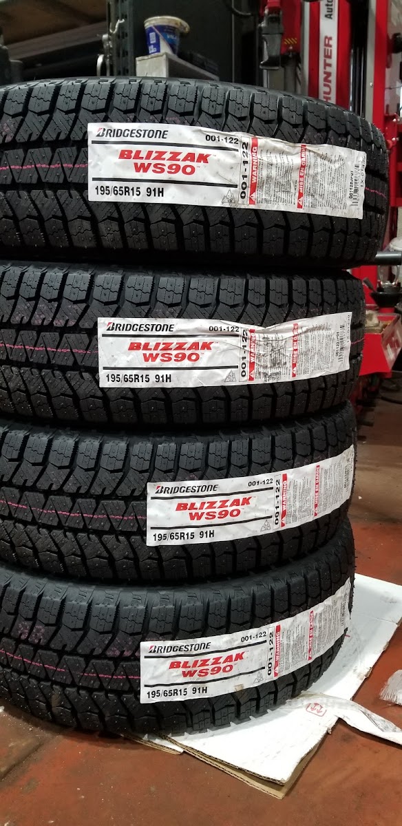 Stack of new Bridgestone Blizzak winter tires at Sure Choice